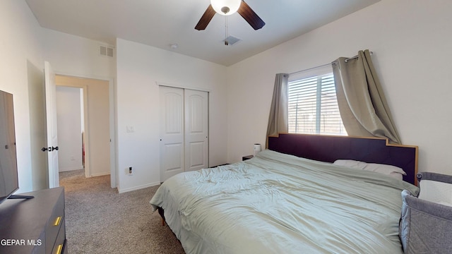 bedroom with light carpet, ceiling fan, and a closet