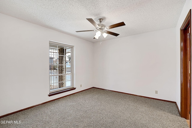 carpeted spare room with a textured ceiling and ceiling fan