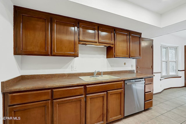 kitchen featuring sink, dishwasher, and light tile patterned flooring