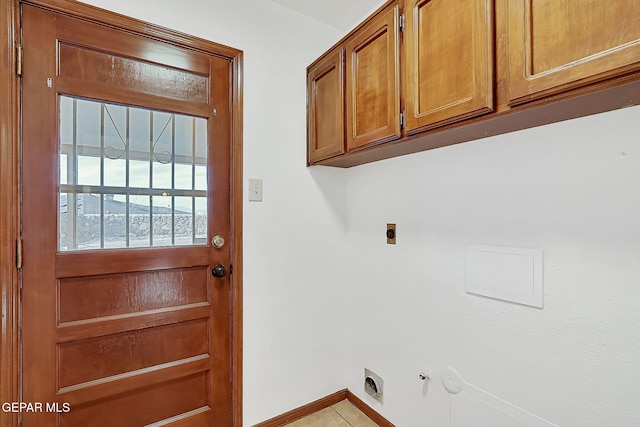 clothes washing area with cabinets, hookup for an electric dryer, and hookup for a gas dryer