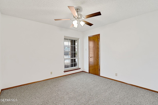 carpeted spare room featuring ceiling fan and a textured ceiling