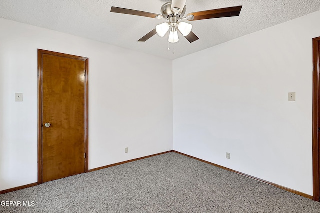 carpeted empty room with ceiling fan and a textured ceiling