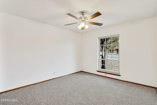 carpeted spare room featuring ceiling fan and a textured ceiling