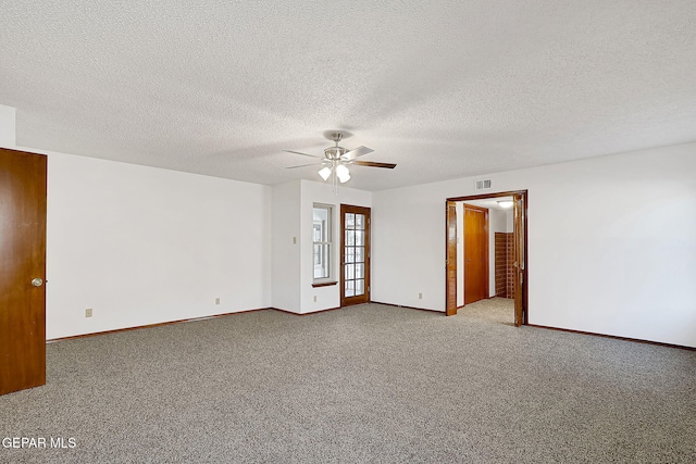 carpeted empty room featuring a textured ceiling and ceiling fan