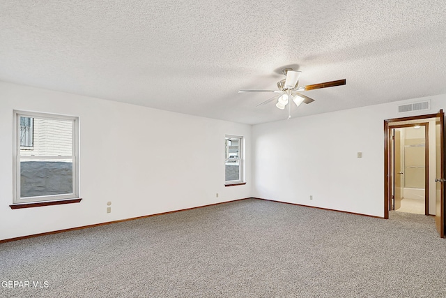 carpeted empty room with a textured ceiling and ceiling fan