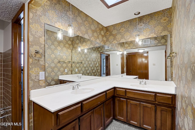 bathroom with vanity and a textured ceiling