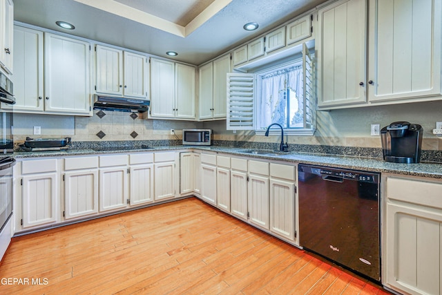 kitchen with white cabinetry, sink, and black appliances