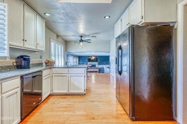 kitchen featuring ceiling fan, white cabinetry, light hardwood / wood-style floors, black appliances, and kitchen peninsula