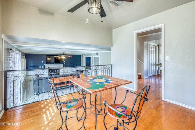 dining area featuring hardwood / wood-style floors and ceiling fan