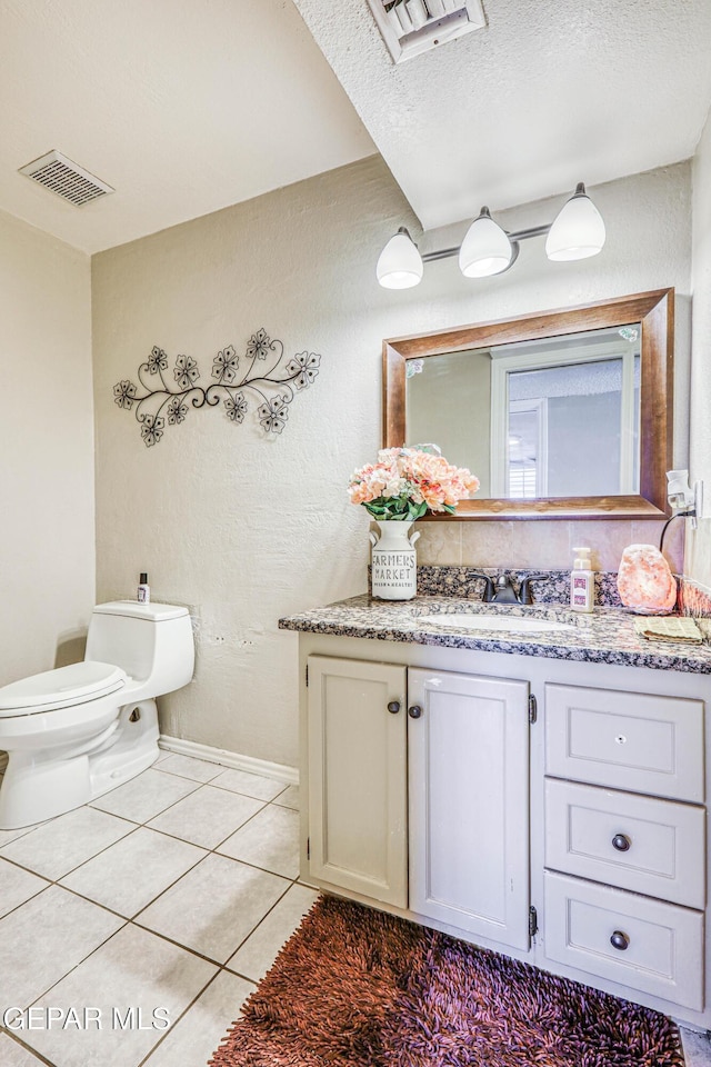 bathroom with tile patterned floors, toilet, and vanity