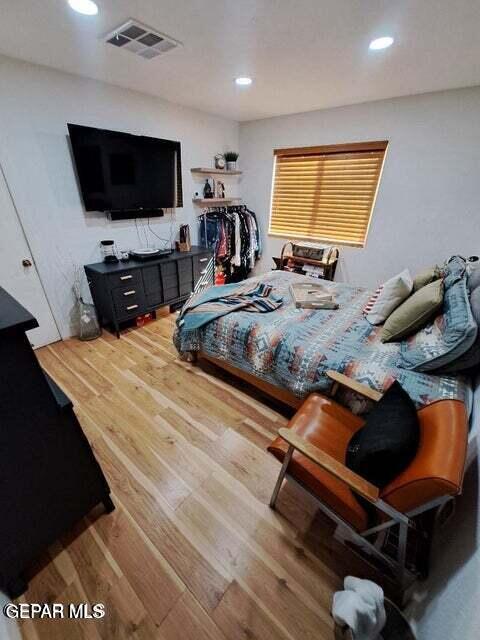 bedroom with hardwood / wood-style floors