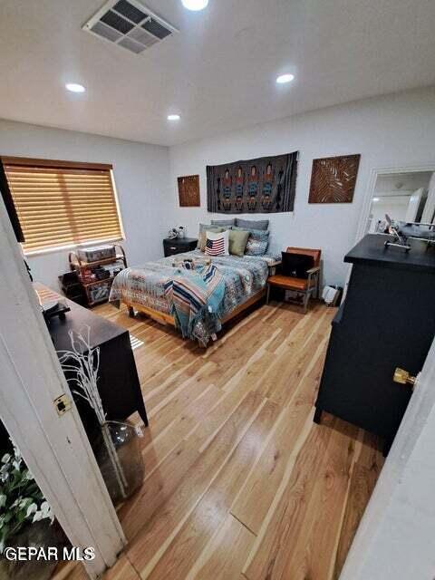 bedroom with wood-type flooring