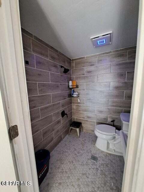 bathroom with tile patterned floors and toilet