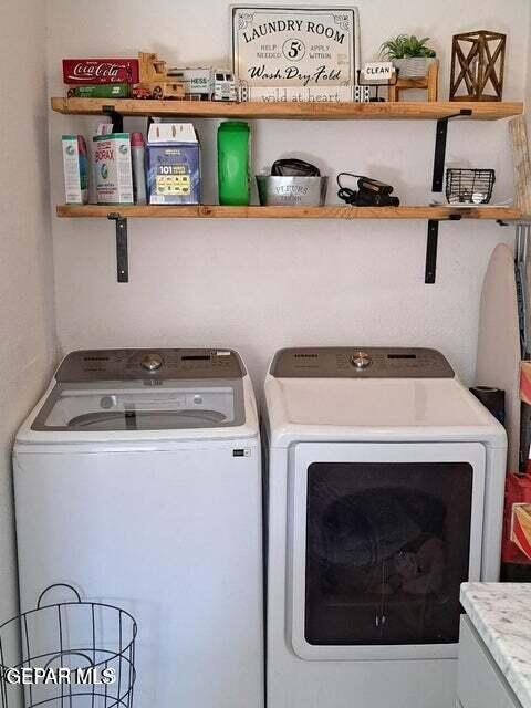 washroom with washer and dryer