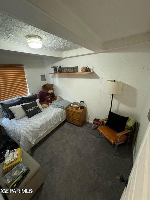 carpeted bedroom featuring a textured ceiling