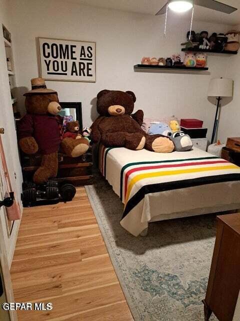 bedroom featuring hardwood / wood-style floors and ceiling fan