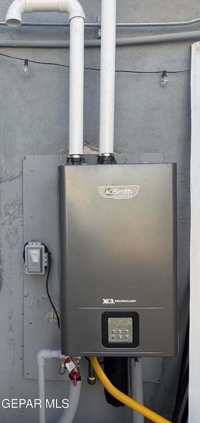 utility room featuring tankless water heater