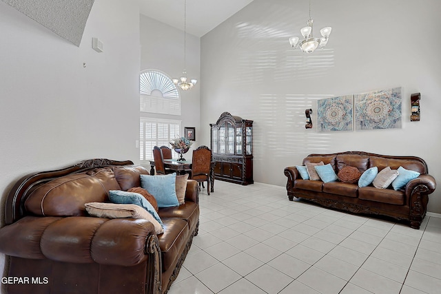 living room with an inviting chandelier, light tile patterned flooring, and high vaulted ceiling