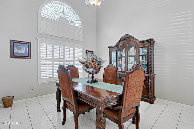 tiled dining room featuring a high ceiling