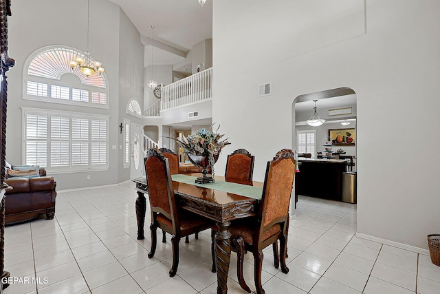 dining space featuring a notable chandelier, light tile patterned floors, and a wealth of natural light