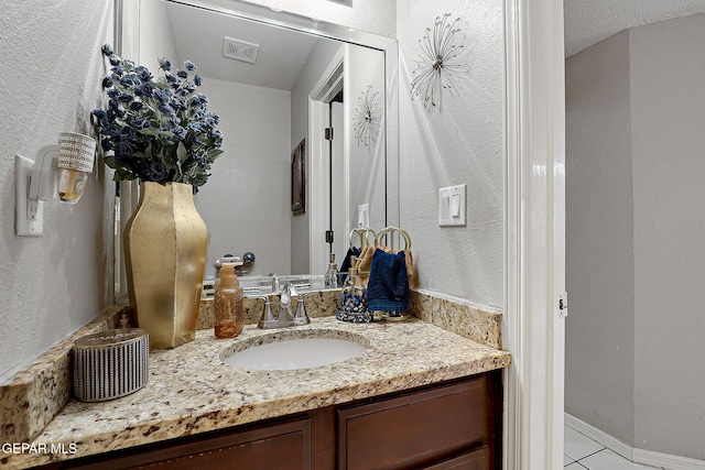 bathroom featuring tile patterned floors and vanity