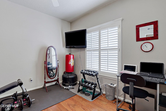 office featuring hardwood / wood-style floors, a textured ceiling, and ceiling fan