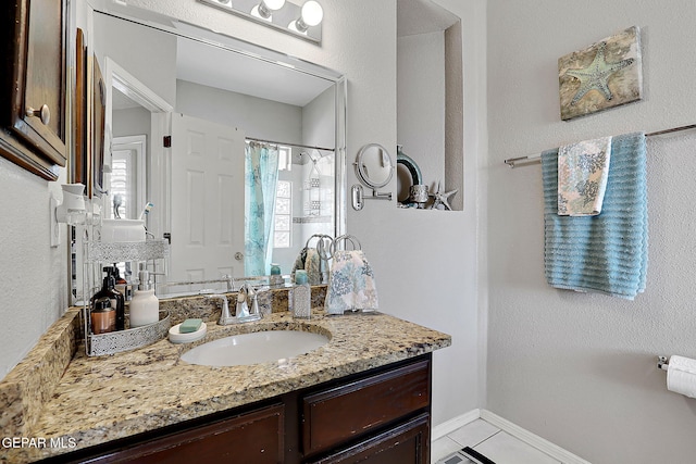 bathroom featuring vanity and a shower with shower curtain