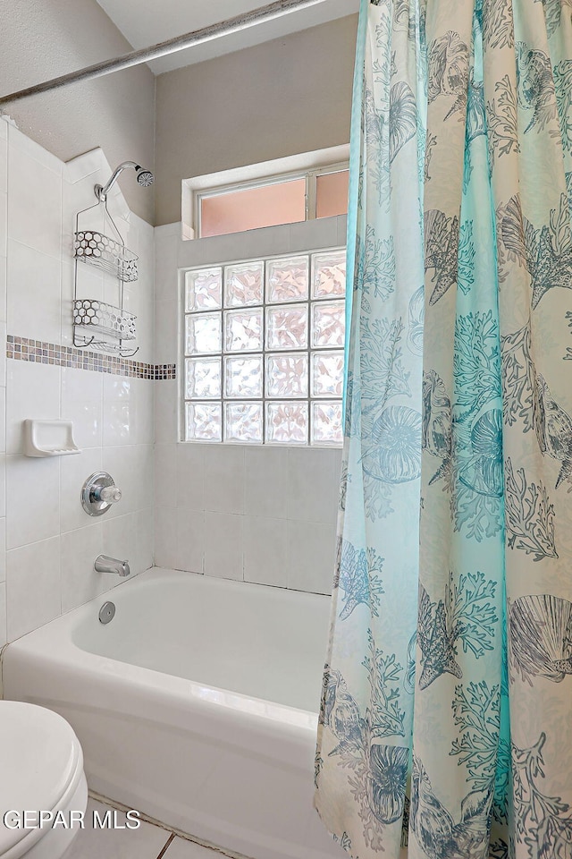 bathroom with toilet and shower / bathtub combination with curtain