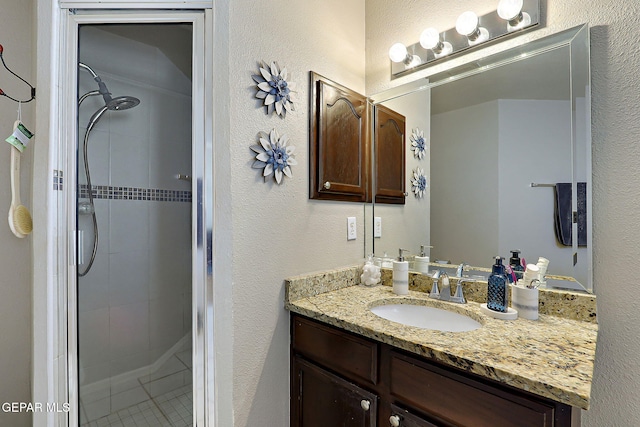 bathroom featuring walk in shower and vanity