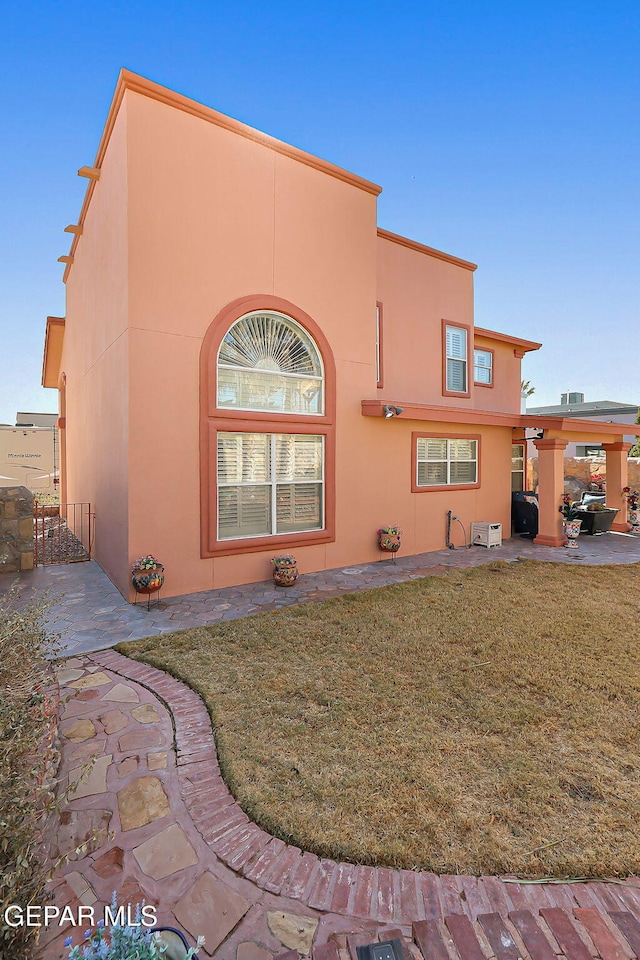 view of side of home featuring a lawn