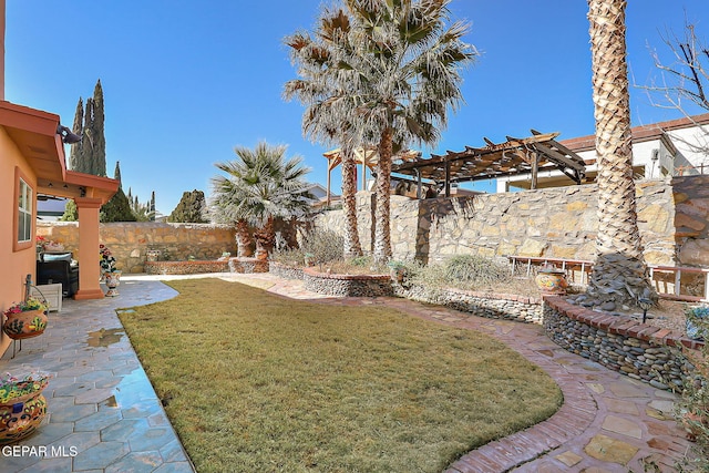 view of yard with a pergola and a patio area