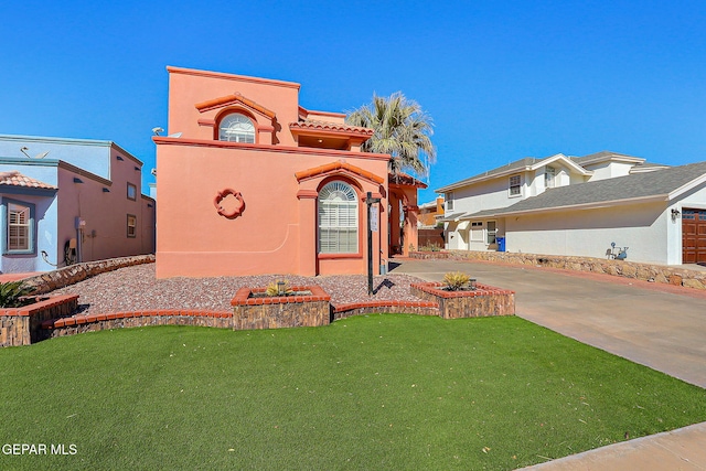 view of front of house featuring a garage and a front lawn