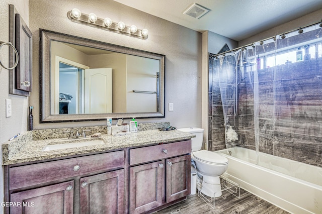 full bathroom featuring vanity, wood-type flooring, toilet, and shower / tub combo with curtain