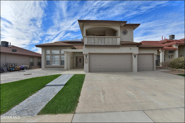 view of front of house with a garage and a balcony