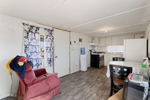 kitchen featuring stainless steel range with electric stovetop, hardwood / wood-style floors, white fridge, and white cabinets