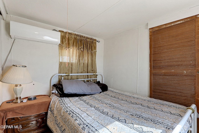 bedroom featuring a wall mounted air conditioner