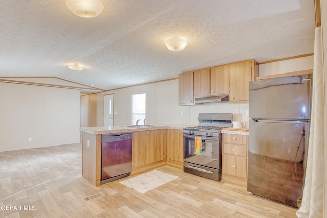 kitchen with dishwasher, stainless steel range with gas stovetop, light brown cabinetry, and refrigerator