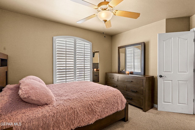 bedroom with light carpet and ceiling fan