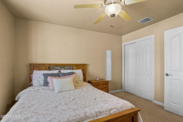 bedroom with ceiling fan, light colored carpet, and a closet