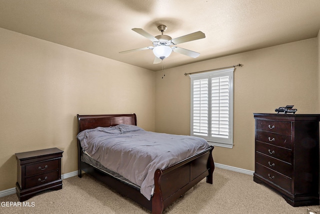 bedroom featuring light carpet and ceiling fan