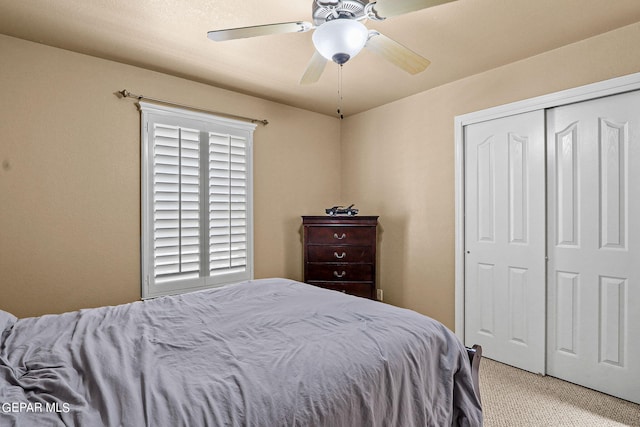 carpeted bedroom featuring a closet and ceiling fan