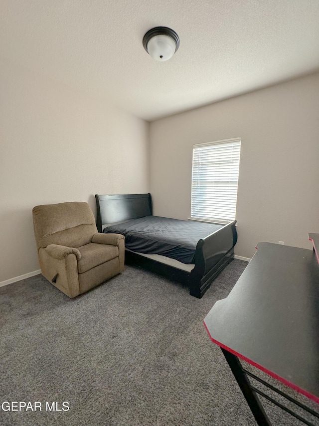 carpeted bedroom featuring a textured ceiling