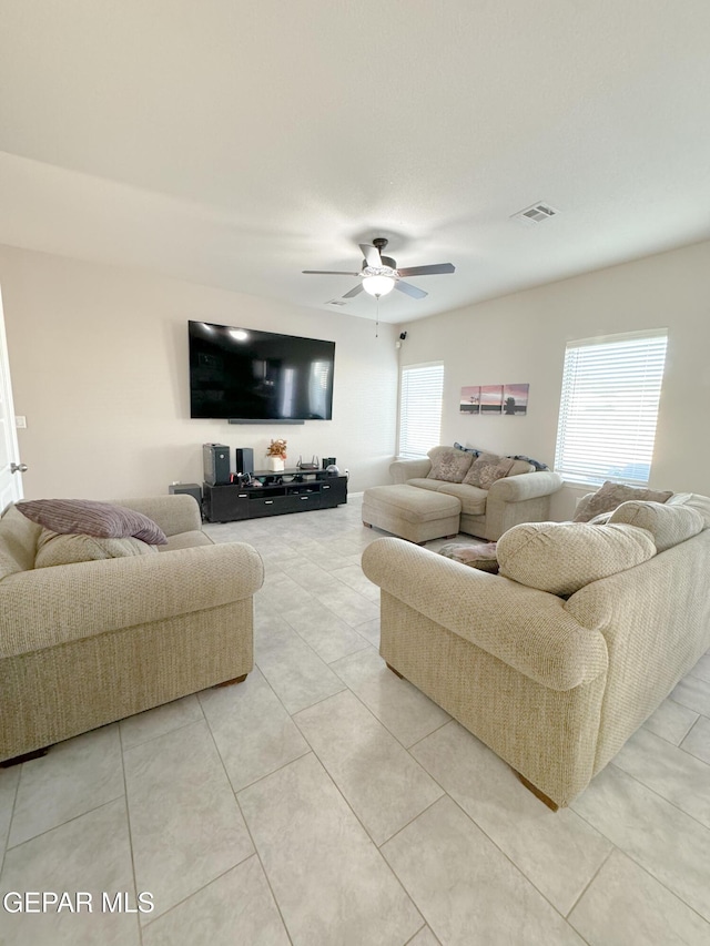 tiled living room with ceiling fan