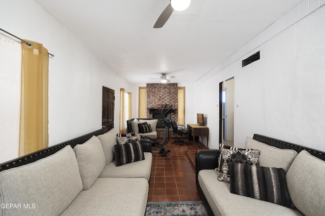 5047 Conley Rd, El Paso, TX 79932 - living room featuring dark tile patterned floors, a fireplace, and ceiling fan