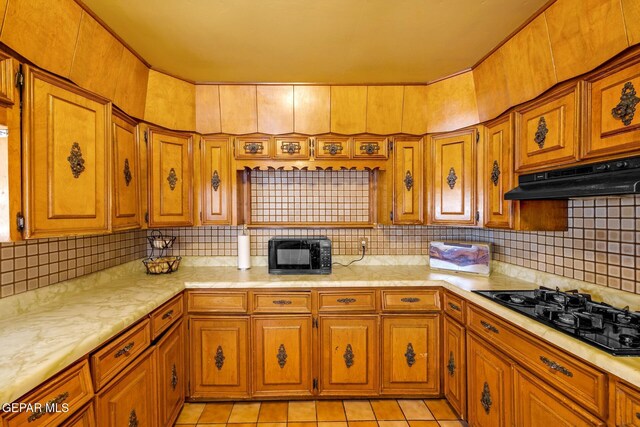 5047 Conley Rd, El Paso, TX 79932 - kitchen with light tile patterned flooring, decorative backsplash, and black appliances