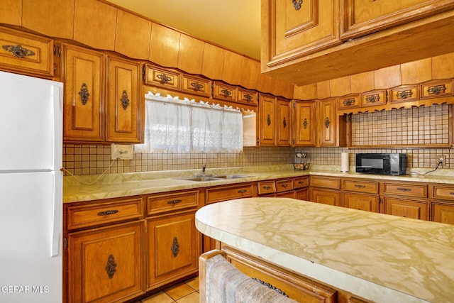 5047 Conley Rd, El Paso, TX 79932 - kitchen featuring light tile patterned flooring, sink, white fridge, and backsplash