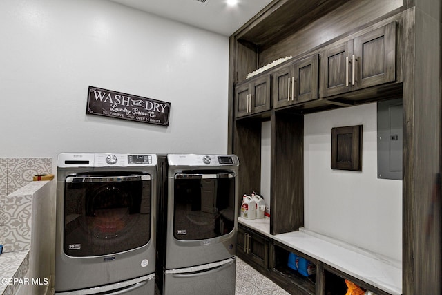 washroom featuring cabinets, washer and dryer, and electric panel