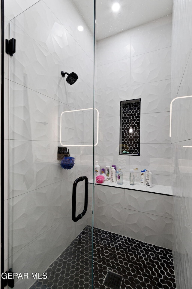 bathroom with a shower with shower door