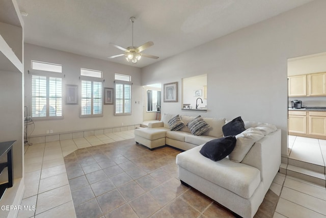 living room featuring light tile patterned flooring and ceiling fan