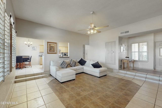 living room with ceiling fan with notable chandelier, tile patterned flooring, and visible vents